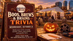 Boos, Brews & Brains trivia sign for October 21 at Shipgarten, beside a glowing jack-o’-lantern, film reel, and vinyl record.